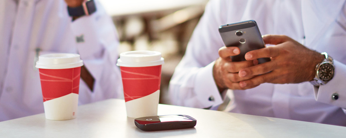 Postpaid Rates - Image A man using the phone