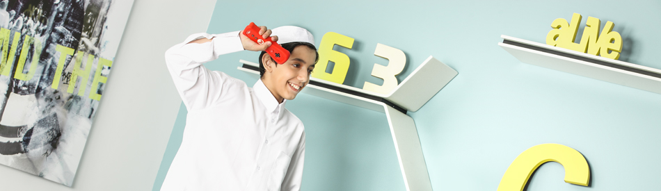 A boy holding a game console