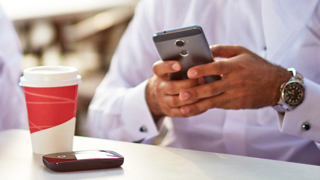 man typing on phone